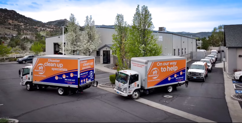 911-restoration-reno-disaster-cleanup-trucks 911 Restoration disaster cleanup trucks outside Reno facility, ready to respond to emergency restoration services