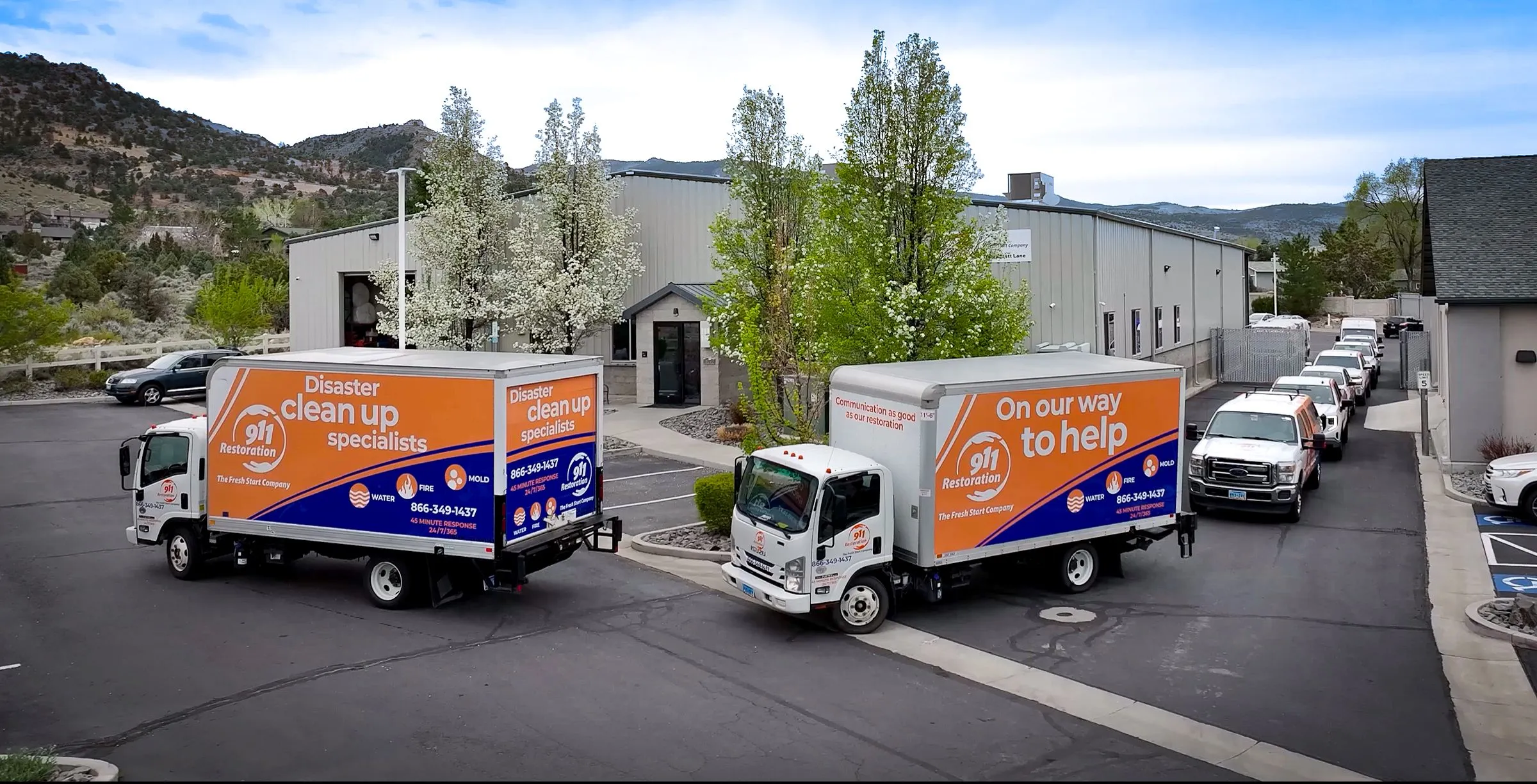 911-restoration-reno-disaster-cleanup-trucks 911 Restoration disaster cleanup trucks outside Reno facility, ready to respond to emergency restoration services