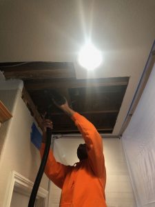 A Technician Making Roof Repairs After a Wildfire Affected a Home in Northwest Reno